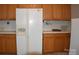 White appliances and wood cabinets in this kitchen at 1217 Tom Joye Rd, Clover, SC 29710