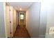 Hallway with wood-look tile floors and access to bedrooms and bath at 410 Clinton Dr, Kings Mountain, NC 28086