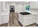 Updated kitchen with white cabinets, gas cooktop, and wood-look floors at 138 Bufflehead Dr, Mooresville, NC 28117