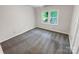 Well-lit bedroom with gray carpet and a window overlooking the backyard at 138 Bufflehead Dr, Mooresville, NC 28117