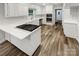 Modern kitchen with white cabinets, stainless steel appliances, and wood-look floors at 138 Bufflehead Dr, Mooresville, NC 28117