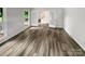 Living room with wood-look floors and French doors leading to the backyard at 138 Bufflehead Dr, Mooresville, NC 28117
