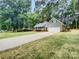 House exterior with driveway and mature trees at 138 Bufflehead Dr, Mooresville, NC 28117