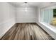 Dining room with wood-look floors and a large window at 138 Bufflehead Dr, Mooresville, NC 28117