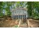 Lakefront home exterior with a screened porch and stairs leading to the lake at 192 Clearview Point Dr, Mount Gilead, NC 27306