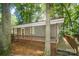 Lakefront home with gray siding, wooden deck, and lake view at 192 Clearview Point Dr, Mount Gilead, NC 27306
