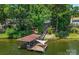 Aerial view of lakefront property with a dock and boathouse at 192 Clearview Point Dr, Mount Gilead, NC 27306