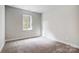 Spacious bedroom with plush carpeting and a large window at 2024 Cedar Falls Dr # 9, Waxhaw, NC 28173