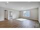 Sunlit bedroom featuring hardwood floors and access to other rooms at 2024 Cedar Falls Dr # 9, Waxhaw, NC 28173