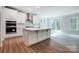 Modern kitchen with white cabinets, island, and stainless steel appliances at 2024 Cedar Falls Dr # 9, Waxhaw, NC 28173