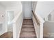 Modern carpeted staircase with wooden handrail at 2024 Cedar Falls Dr # 9, Waxhaw, NC 28173