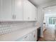 White shaker cabinets, hexagonal tile backsplash, quartz countertop at 2024 Cedar Falls Dr # 9, Waxhaw, NC 28173