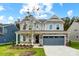 Two-story home with gray siding and stone accents at 2024 Cedar Falls Dr # 9, Waxhaw, NC 28173