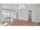 Open living room featuring hardwood floors, fireplace and chandelier at 9837 Jubilee Ct, Charlotte, NC 28215