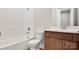 Clean bathroom with subway tile and wood vanity at 9837 Jubilee Ct, Charlotte, NC 28215