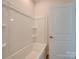 Clean bathroom with shower/tub combo and built-in shelves at 253 Franklin Nw Ave, Concord, NC 28025
