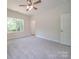 Well-lit bedroom with a ceiling fan and large window at 253 Franklin Nw Ave, Concord, NC 28025