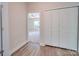 Hallway with wood-look floors and access to bedroom and closet at 253 Franklin Nw Ave, Concord, NC 28025
