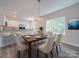 Dining room features a wood table and neutral chairs, with kitchen view at 253 Franklin Nw Ave, Concord, NC 28025