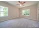 Bright bedroom featuring ceiling fan and two windows at 253 Franklin Nw Ave, Concord, NC 28025