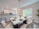 Elegant dining room with marble table, neutral chairs and kitchen view at 253 Franklin Nw Ave, Concord, NC 28025
