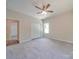 Bedroom with ceiling fan, double closet, and access to hallway at 253 Franklin Nw Ave, Concord, NC 28025