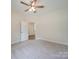 Spacious bedroom with ceiling fan and carpet flooring at 253 Franklin Nw Ave, Concord, NC 28025