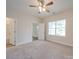 Spacious bedroom with ceiling fan and carpet flooring at 253 Franklin Nw Ave, Concord, NC 28025