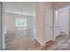 Bright hallway with light wood laminate flooring, leading to various rooms at 253 Franklin Nw Ave, Concord, NC 28025