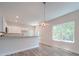 Open dining area with wood-look floors and a modern chandelier at 253 Franklin Nw Ave, Concord, NC 28025