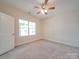 Bright bedroom with large window and carpet flooring at 253 Franklin Nw Ave, Concord, NC 28025