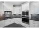 Modern kitchen features white cabinets, stainless steel appliances, and dark countertops at 531 Coman Ln, Kings Mountain, NC 28086