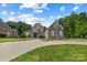 Two-story home with stone and brick exterior, landscaping, and driveway at 531 Coman Ln, Kings Mountain, NC 28086