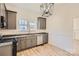Renovated kitchen features gray cabinets, granite countertops, and stainless steel appliances at 1228 N Main St, Salisbury, NC 28144