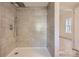 Modern shower with gray tile and built-in shelving at 1228 N Main St, Salisbury, NC 28144