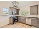 Renovated kitchen features gray cabinets, granite countertops, and stainless steel appliances at 1228 N Main St, Salisbury, NC 28144