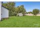 Large backyard with grass, shed, and mature trees at 1228 N Main St, Salisbury, NC 28144