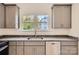 Renovated kitchen features gray cabinets, granite countertops, and stainless steel appliances at 1228 N Main St, Salisbury, NC 28144