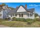 Charming white house with a front porch and well-manicured lawn at 1228 N Main St, Salisbury, NC 28144