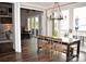 Bright dining area with lake views and rustic farmhouse table at 16339 Stinson Cove Rd, Huntersville, NC 28078