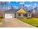 Gray house with yellow accents and a two-car garage at 746 Whites Farm Rd, Statesville, NC 28625