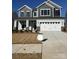 Two-story house with gray siding, white garage door, and landscaping at 10112 Whitaker Pointe Dr, Huntersville, NC 28078