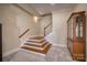 Basement stairway with wooden steps and a charming display cabinet at 3670 West Bay Dr, Sherrills Ford, NC 28673