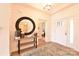 Light and airy entryway with wood console table and large mirror at 132 Alenda Lux Cir # 7, Mooresville, NC 28115
