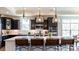 Kitchen island with seating for four and modern lighting at 132 Alenda Lux Cir # 7, Mooresville, NC 28115