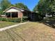 Brick ranch house with carport and manicured hedges at 307 Eddleman Rd, Kannapolis, NC 28083