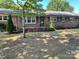 Brick ranch house with landscaped yard and a front porch at 307 Eddleman Rd, Kannapolis, NC 28083