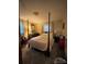 Bedroom with a four-poster bed and carpeted floors at 5419 Stevens Mill Rd, Matthews, NC 28104