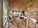 Relaxing screened porch with rocking chairs and brick wall at 5419 Stevens Mill Rd, Matthews, NC 28104