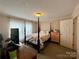 Spacious bedroom with a four poster bed and plenty of closet space at 5401 Stevens Mill Rd, Matthews, NC 28104